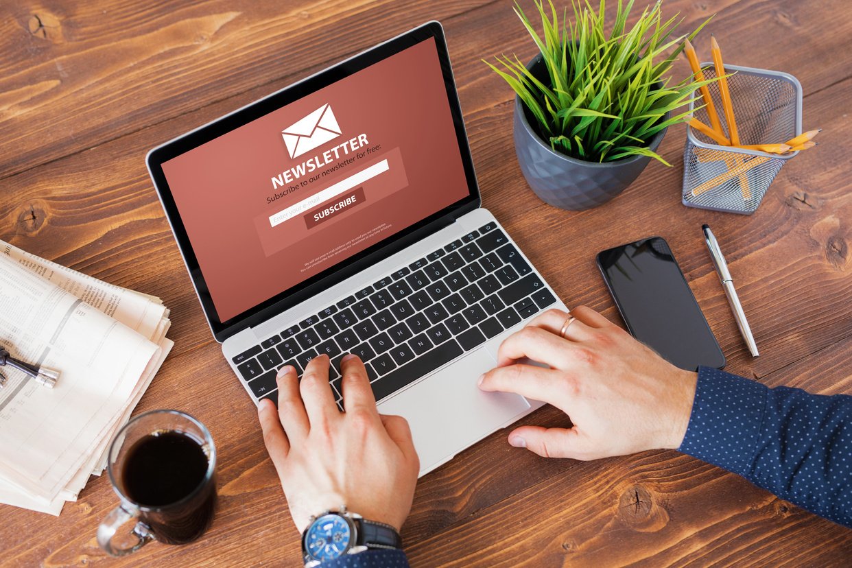 Man Viewing Newsletter Signup Page on His Laptop Screen