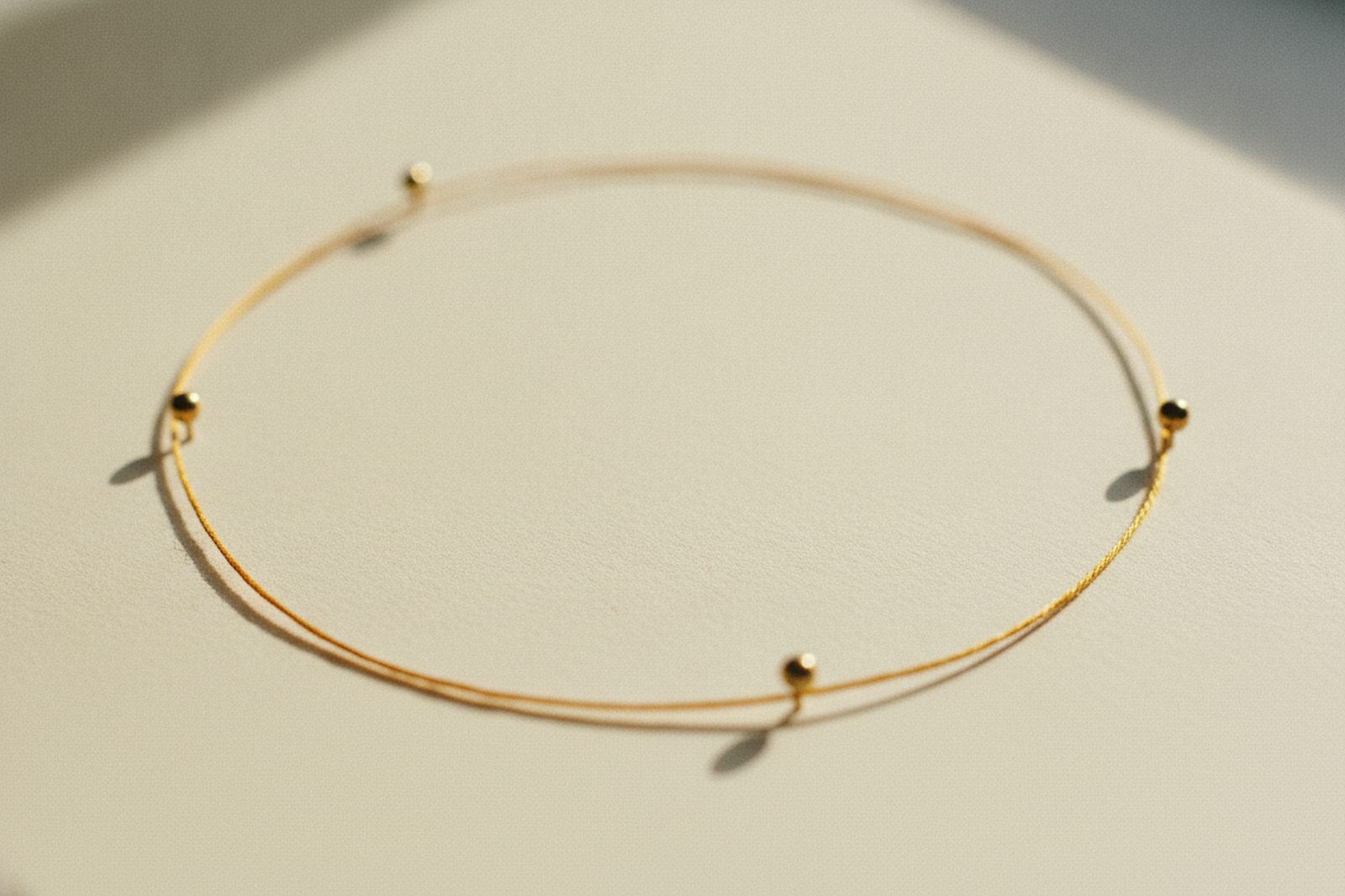 A gold thread loop pinned at four points